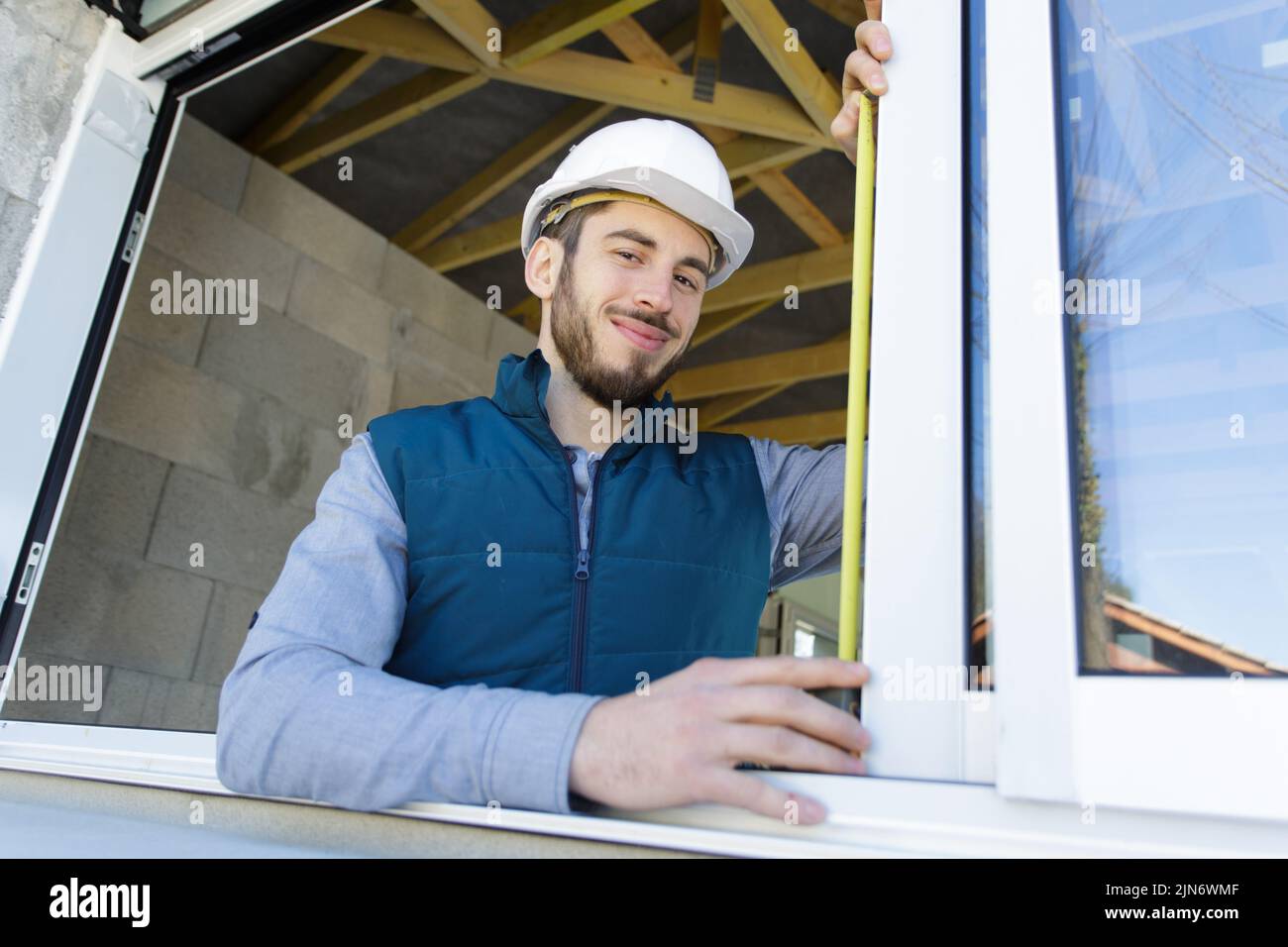 happy man measuring a window Stock Photo