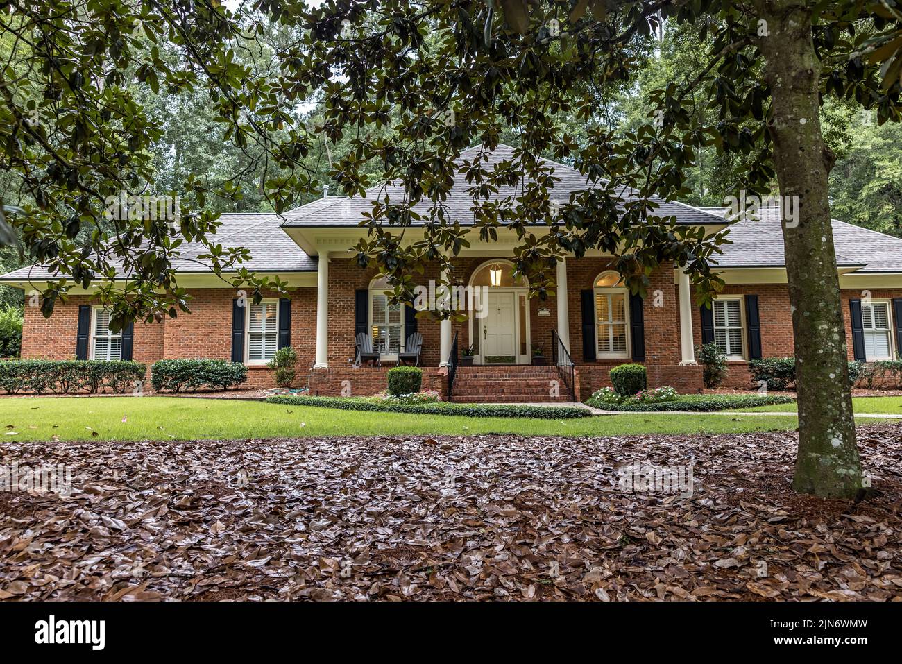 A front side view of an updated spacious red brick ranch traditional