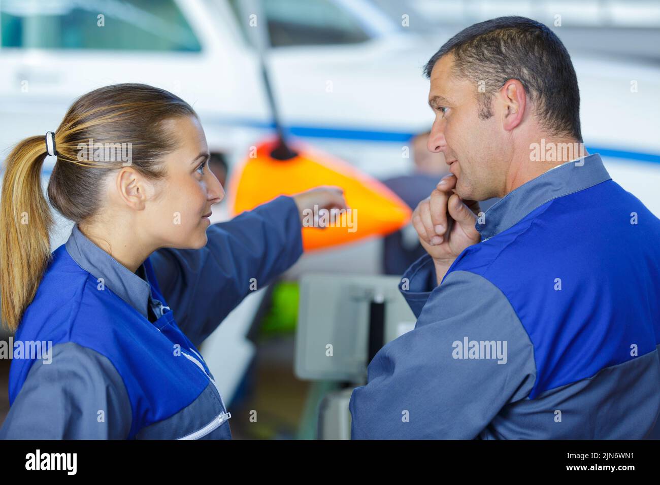man and woman discuss repairs Stock Photo