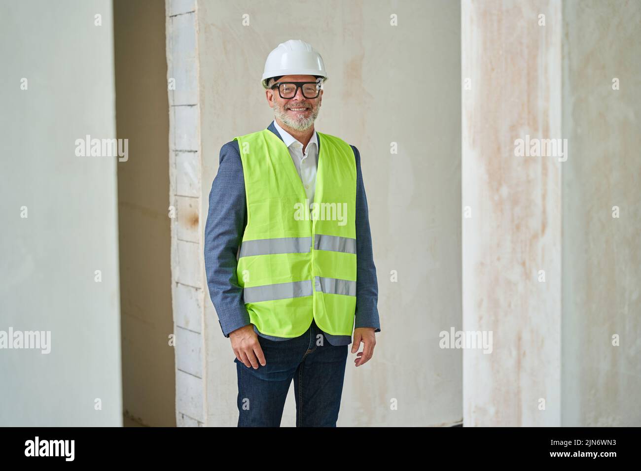 Portrait of adult male foreman in protective helmet at construction Stock Photo