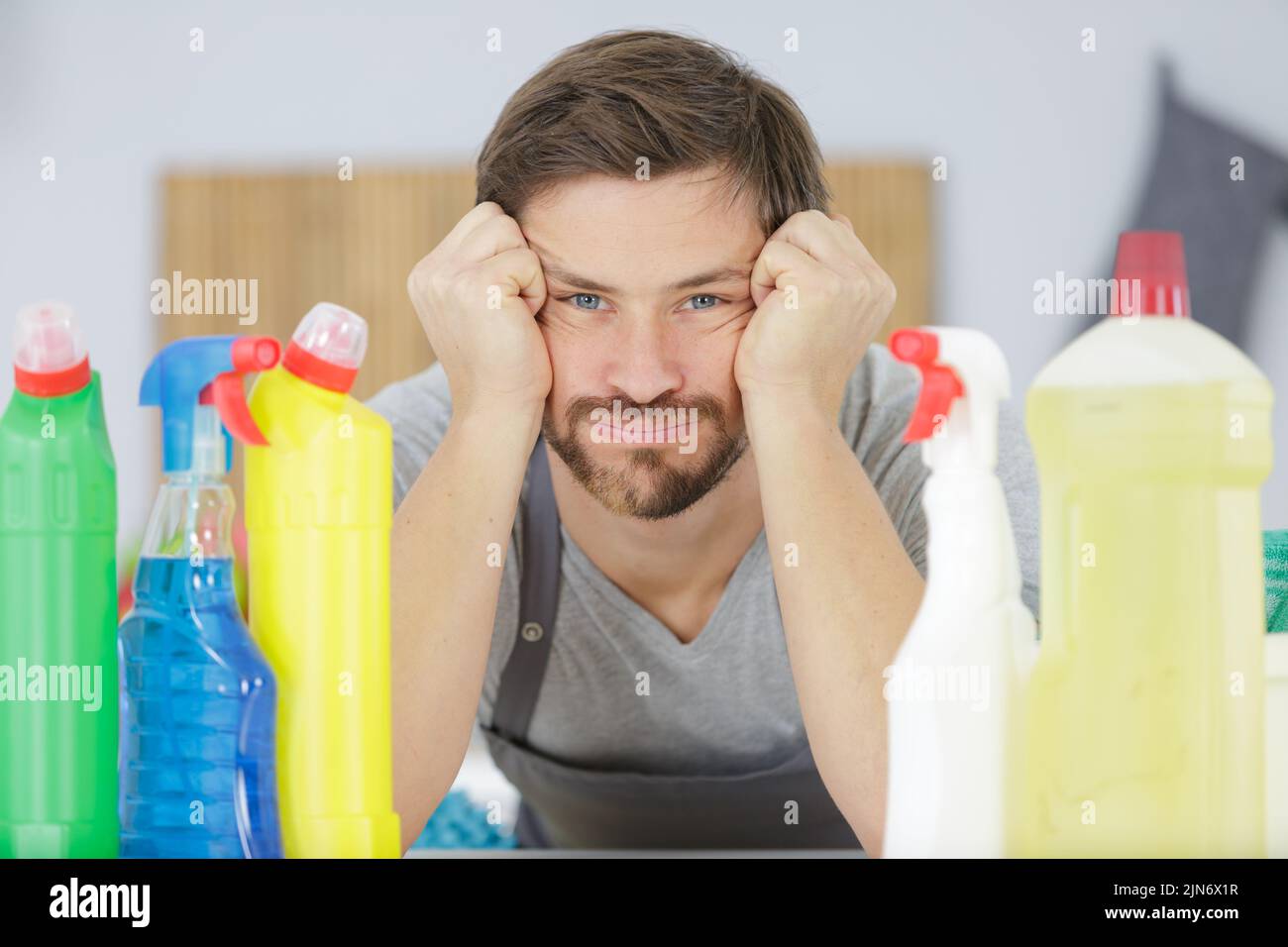 young tired man tired from cleaning Stock Photo