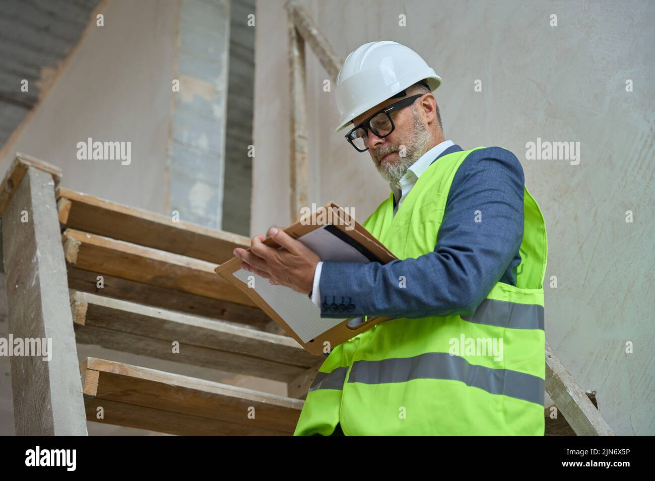 Portrait of male foreman in protective helmet at construction site Stock Photo