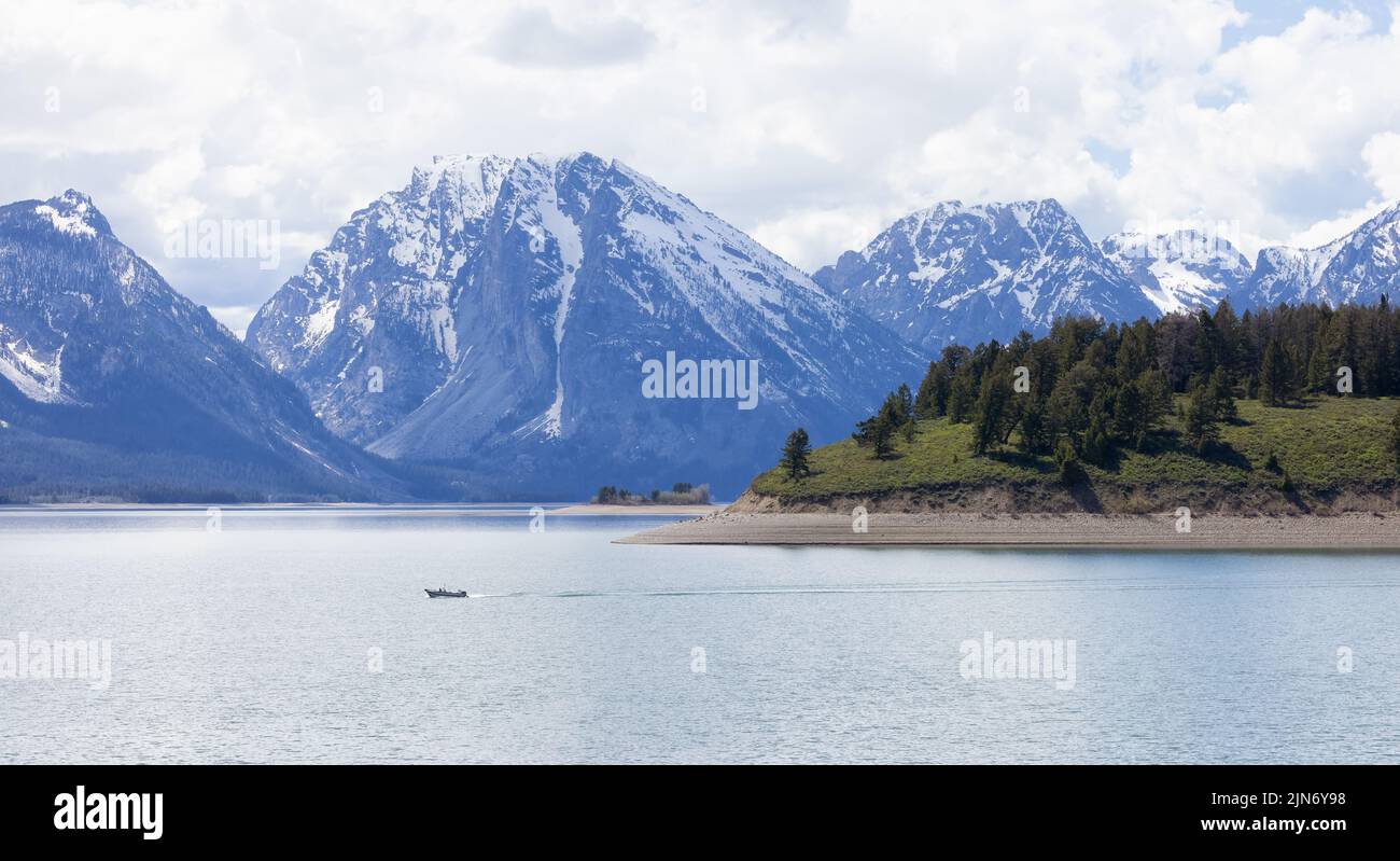 Lake surrounded by Trees and Mountains in American Landscape Stock Photo