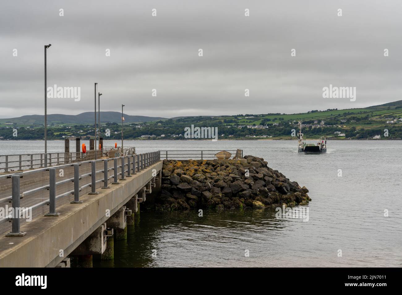 Magilligan Point, United Kingdom - 9 July, 2022: the Lough Foyle Ferry arriving at the pier at Magilligan Point from Ireland Stock Photo