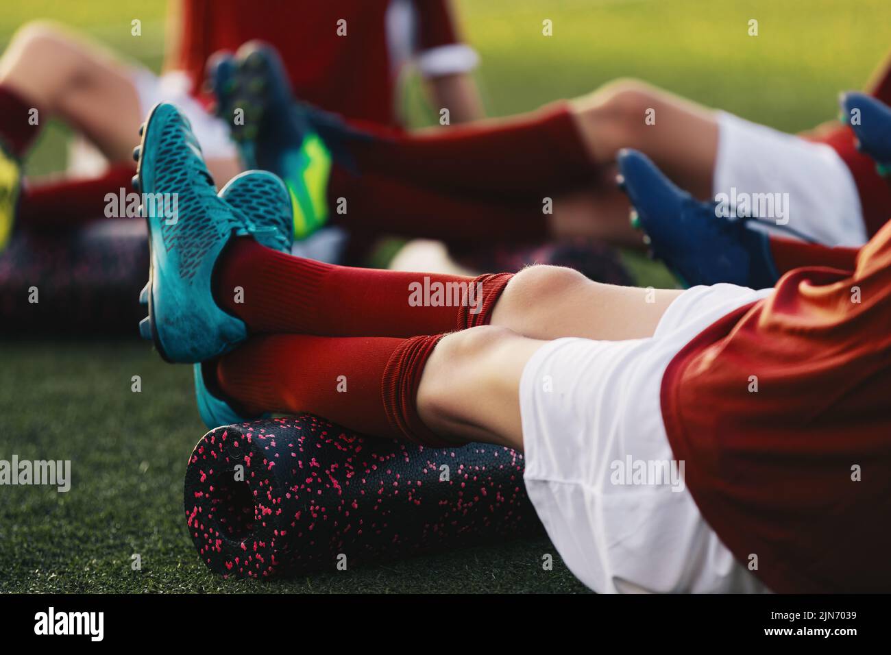 Soccer Football Players in a Team on Fitness Workout to Relieve Muscle