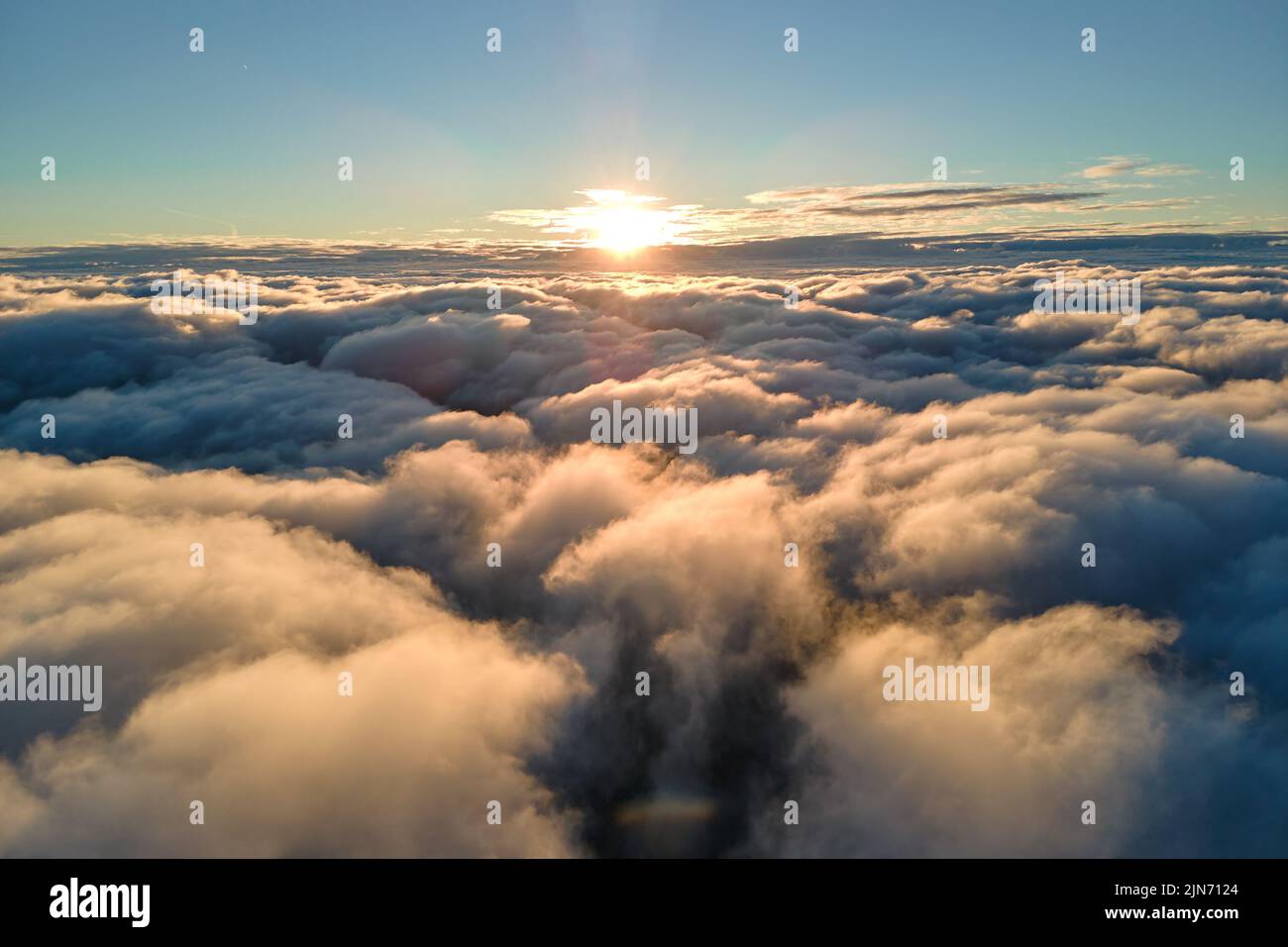 Aerial view from airplane window at high altitude of dense puffy ...