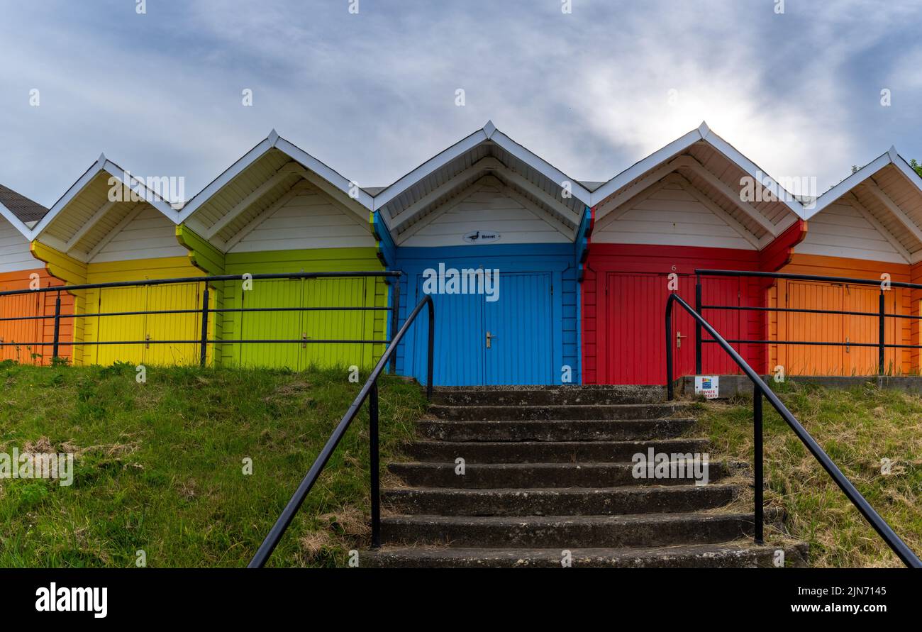 Scarborough, United Kingdom - 16 June, 2022: view of colorful wooden beach huts on the beach of Scarborough in North Yorkshire Stock Photo