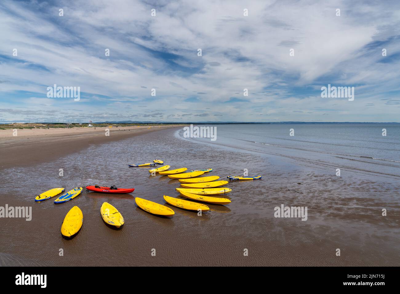 St. Andrews, United Kingdom - 22 June, 2022: many sea kayaks and paddleboards on the beach of St. Andrews in Scotland Stock Photo