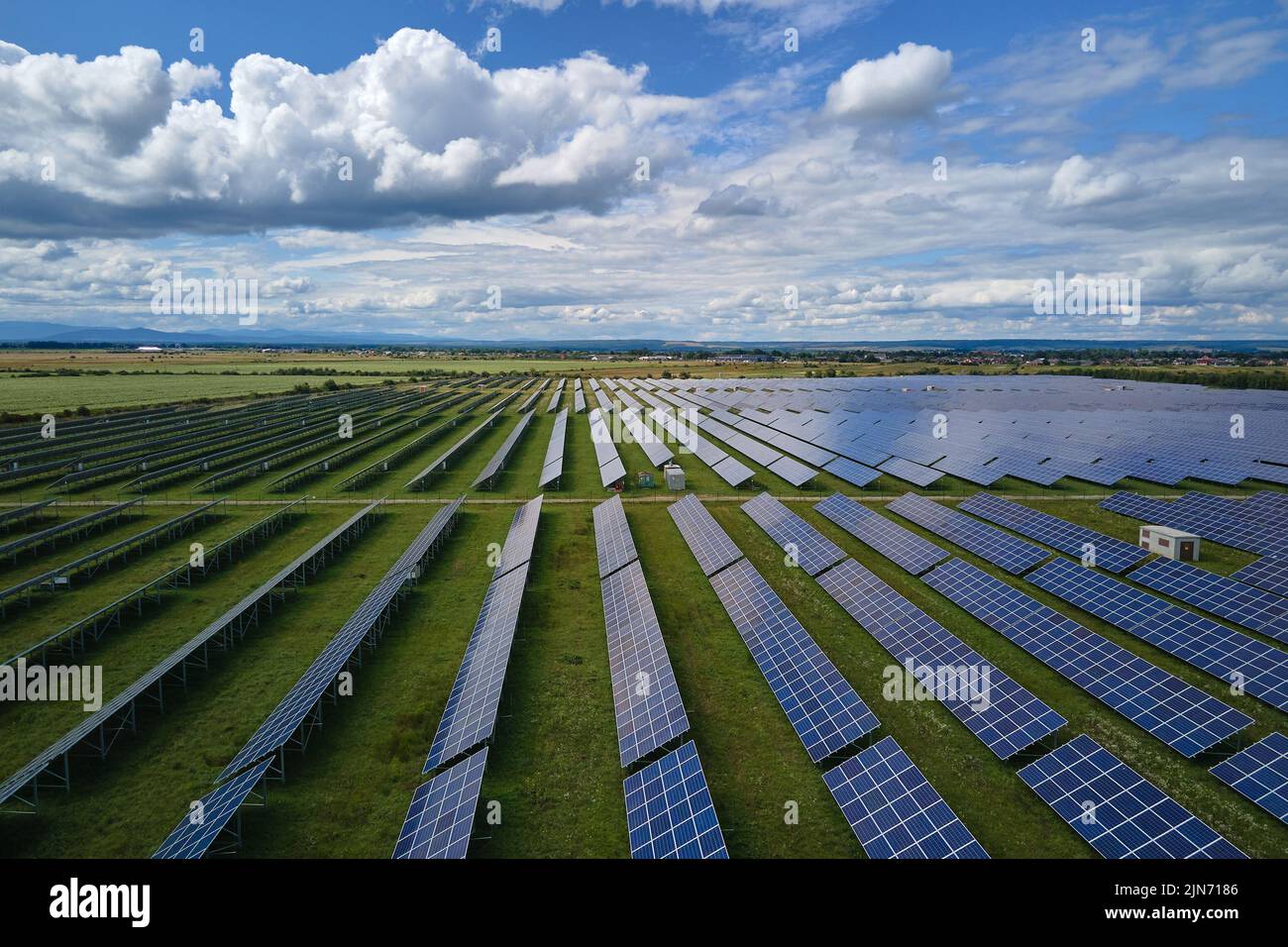 Aerial view of big sustainable electric power plant with many rows of