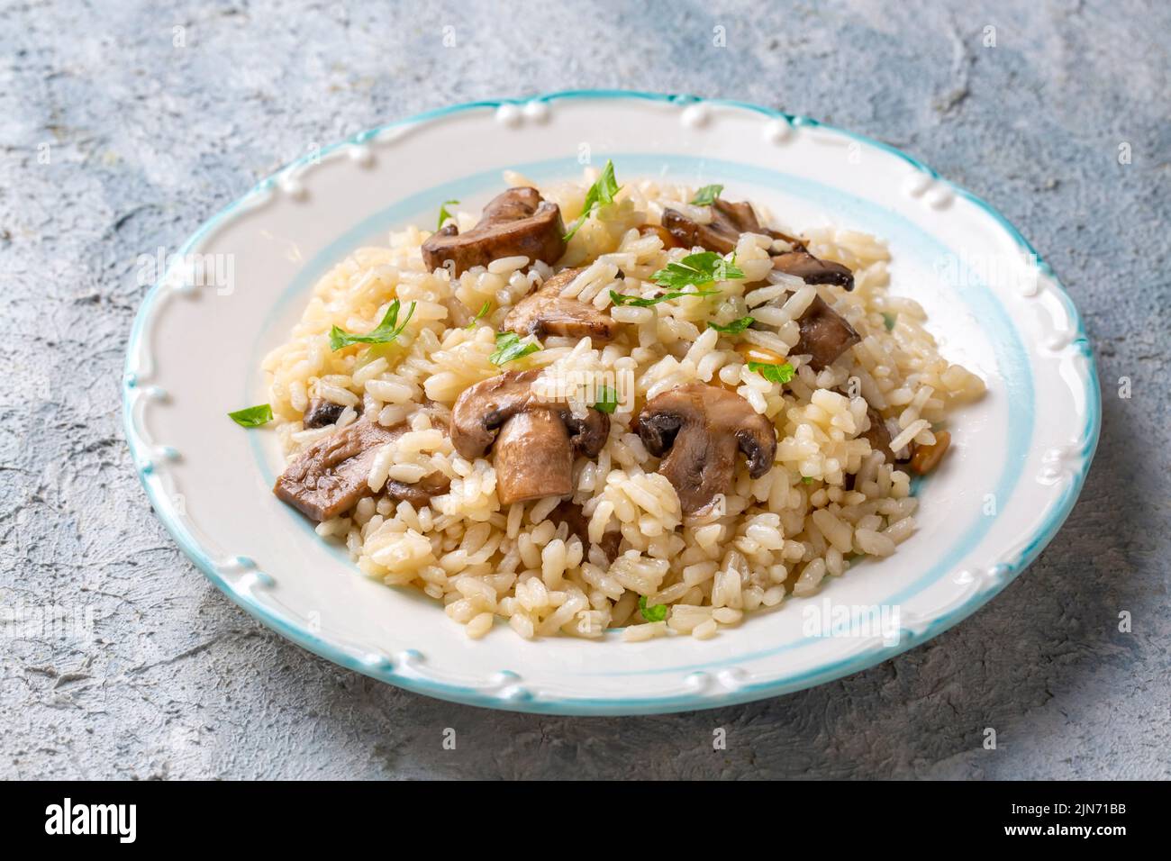 Mussel rice pilaf. Rice with mussels on small white plate on ceramic