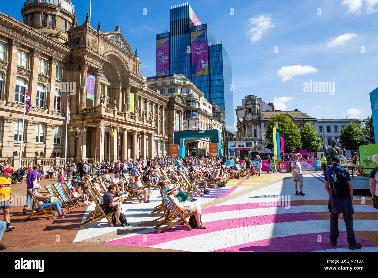 Crowds of people watching The Commonwealth Games 2022 Festival Site in Victoria Square, Birmingham with the ancient architecture of The Council House Stock Photo