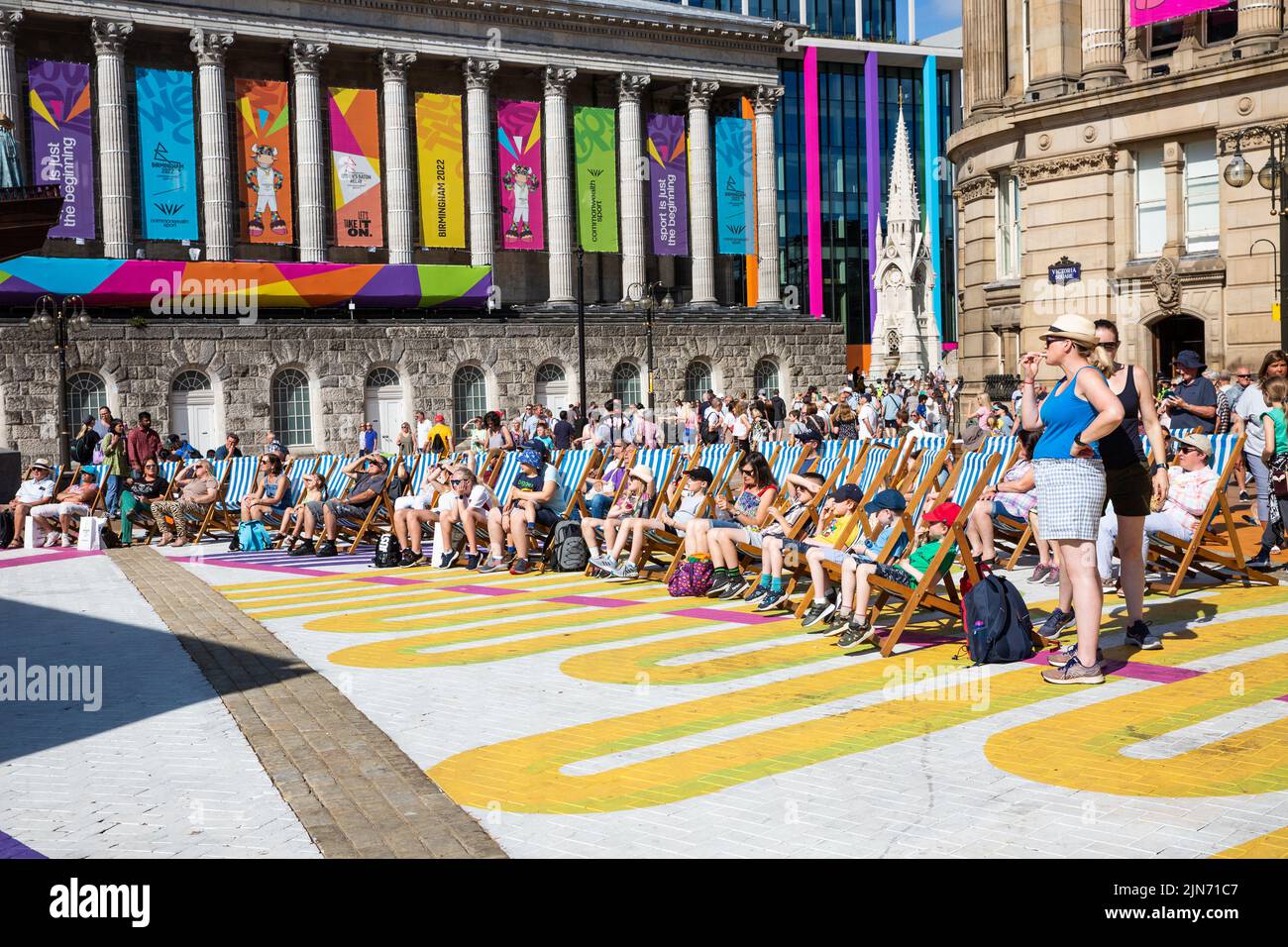 Crowds of people watching The Commonwealth Games 2022 Festival Site in Victoria Square, Birmingham with the ancient architecture of The Council House Stock Photo