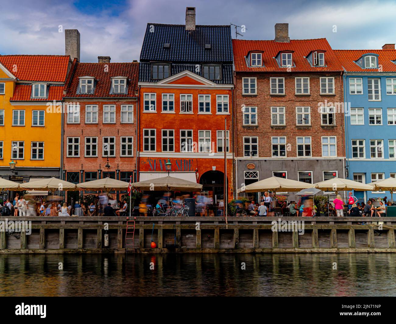 A beautiful shot of a famous tourist spot Nyhavn in Copenhagen with colorful buildings and a waterscape Stock Photo