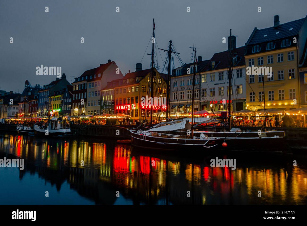 A beautiful shot of a famous tourist spot Nyhavn in Copenhagen with colorful buildings at night Stock Photo