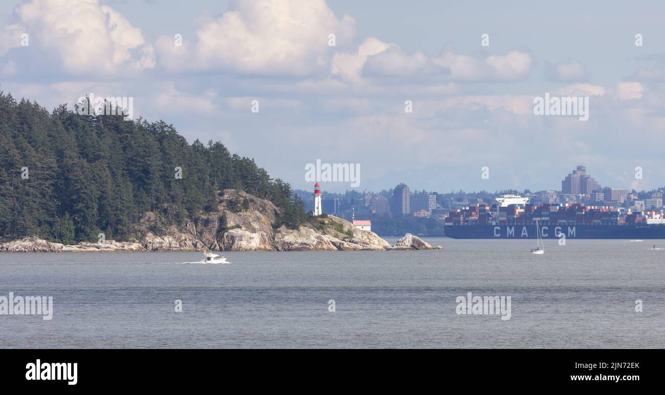 Lighthouse Park, city and industrial ship during sunny summer day. Stock Photo