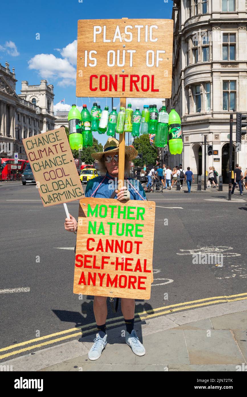 Climate change, and plastic use protester outside the Houses of Parliament, Westminster, London, UK. Global warming protest during heatwave in UK Stock Photo