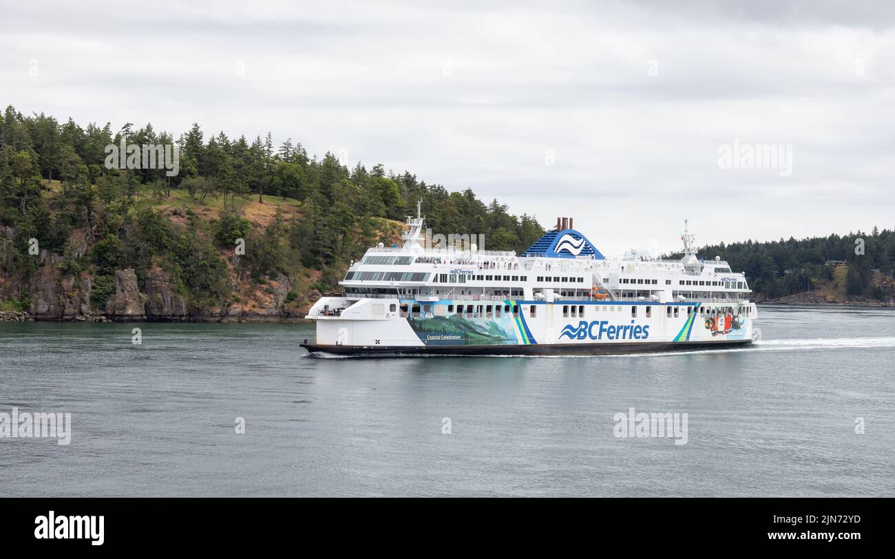 BC Ferries Boat in Pacific Ocean during cloudy summer day. Stock Photo