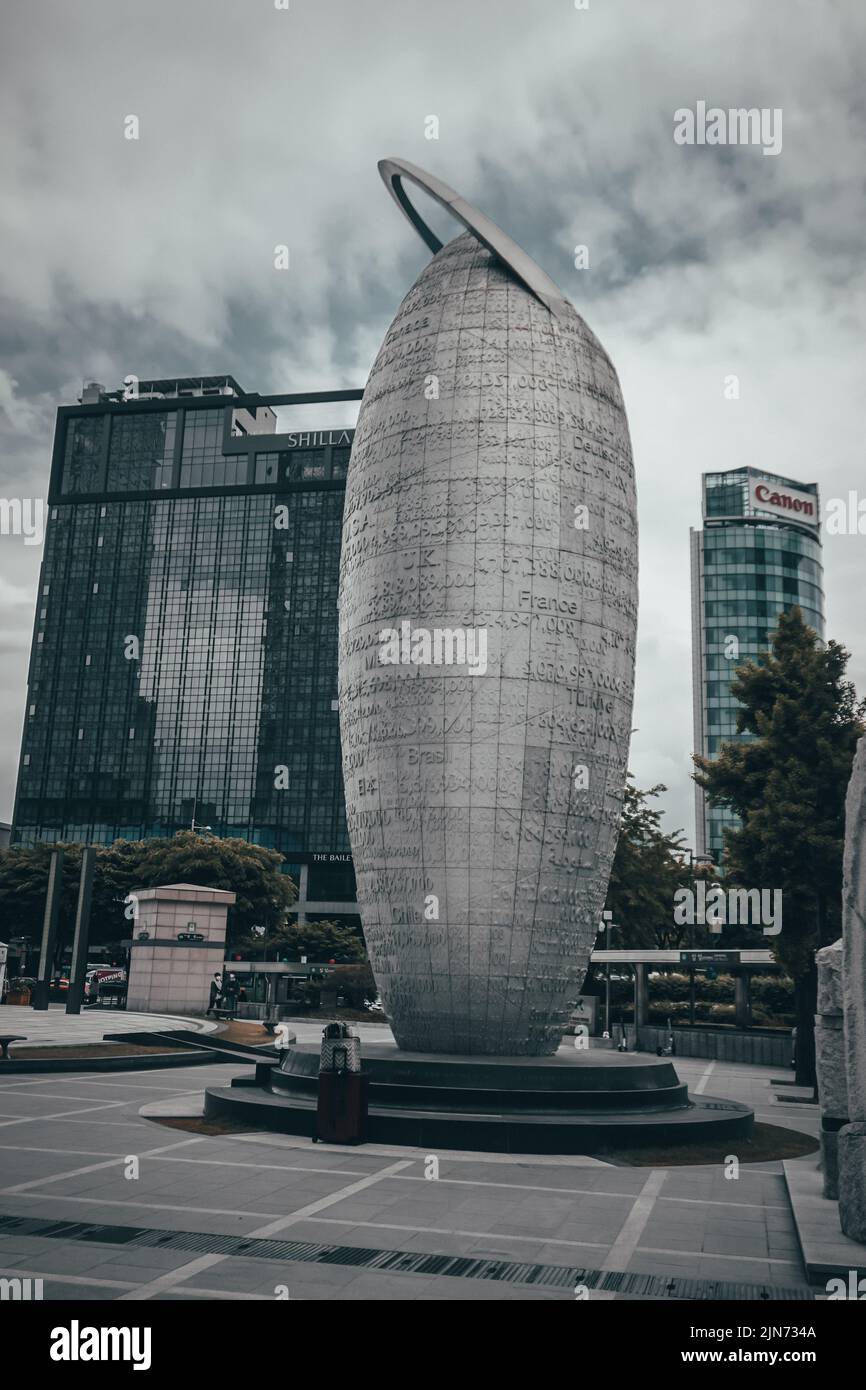 A vertical cloudy shot of a monument in downtown Seoul, Korea Stock Photo