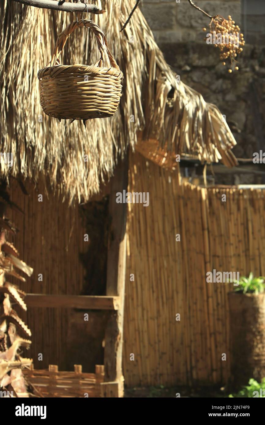 A wicker container, called artal in Lebanon, hanging from a tree branch