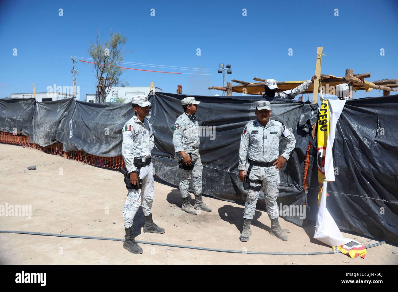 Members of security forces move next to a shaft of a coal mine, where a mine shaft collapsed leaving miners trapped, in Sabinas, Coahuila state, Mexico, August 9, 2022. REUTERS/Luis Cortes Stock Photo