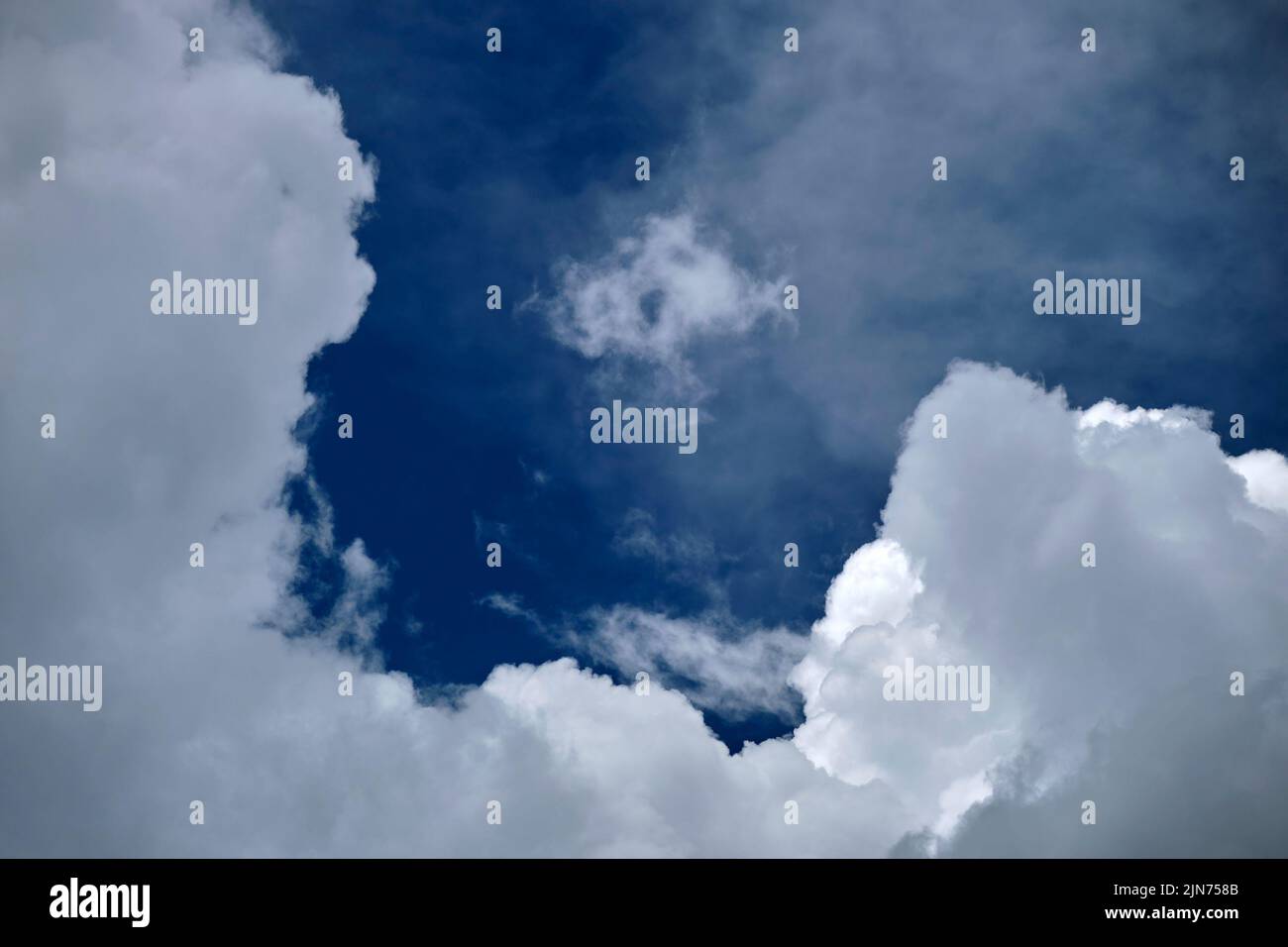 White puffy cumulus clouds on summer blue sky Stock Photo - Alamy