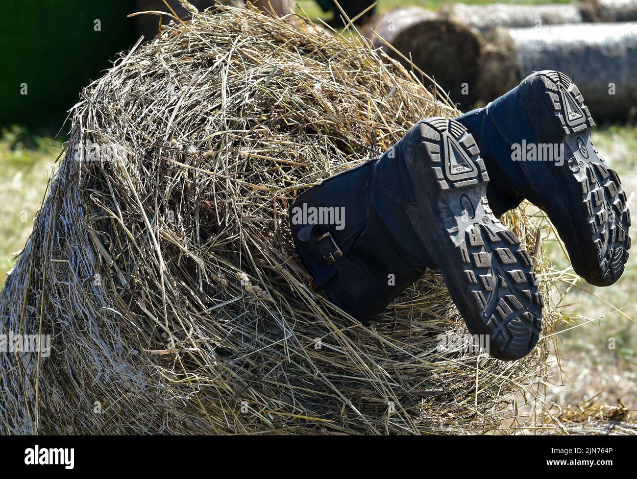 Regional demonstration site of modern technologies in agricultural production 'Field Day 2022' in Novosibirsk. Genre photography. Installation with rubber boots and a haystack. 05.08.2022 Russia, Novosibirsk Photo credit: Vlad Nekrasov/Kommersant/Sipa USA Stock Photo