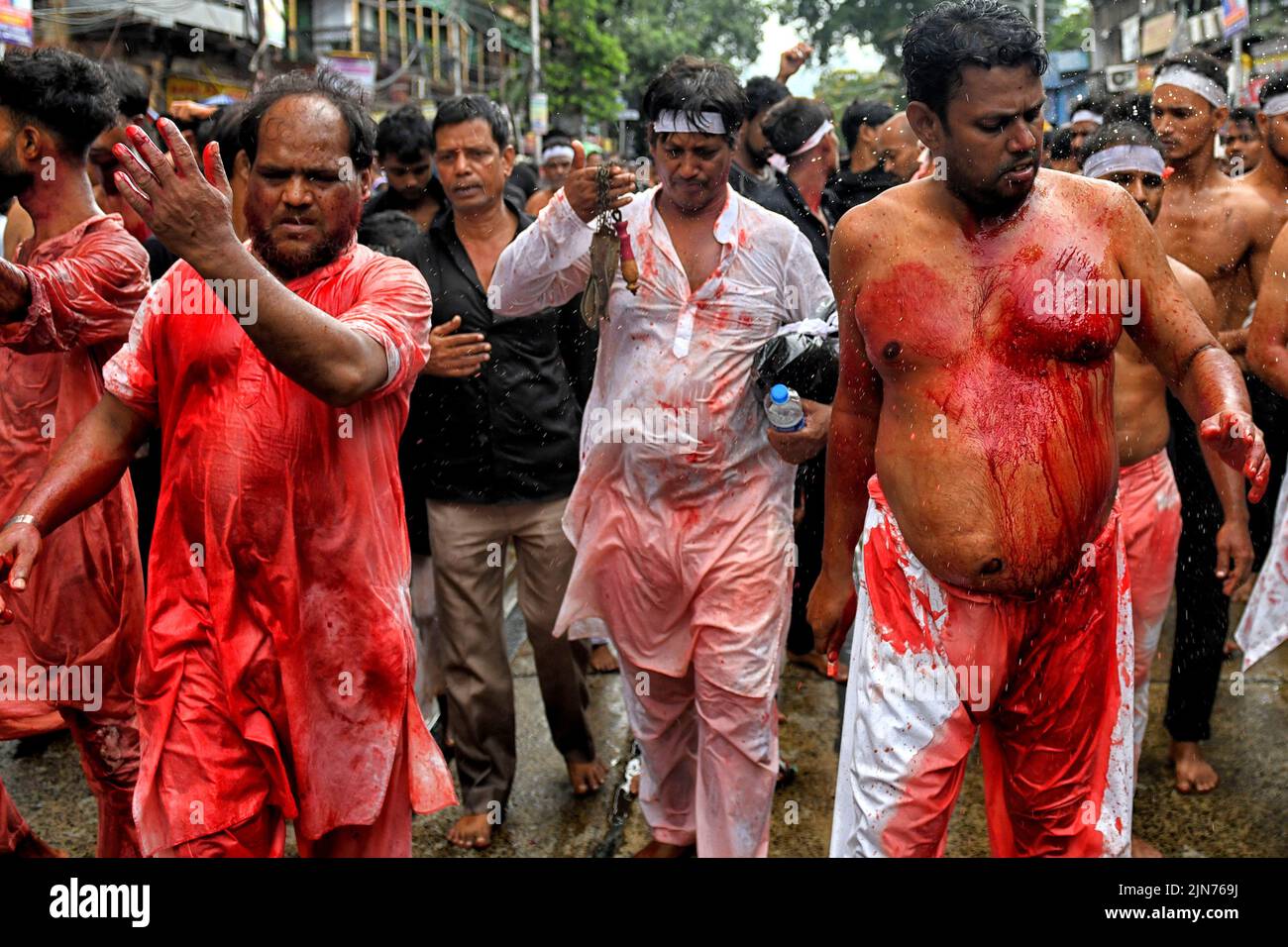 (EDITORS NOTE: Image contains graphic content.) Shi'ite Muslims covered in blood beat their chests and heads with blades & swords during the Muharram procession of Kolkata. Muharram is the first month of the Islamic calendar & Ashura is the tenth day of the month of Muharram on which the commemoration of the martyrdom of Imam Hussain, the grandson of Prophet Muhammad (PBUH), during the battle of Karbala, is done. It is part of Mourning for Shia Muslims and a day of fasting for Sunni Muslims that is observed all over the World. Stock Photo