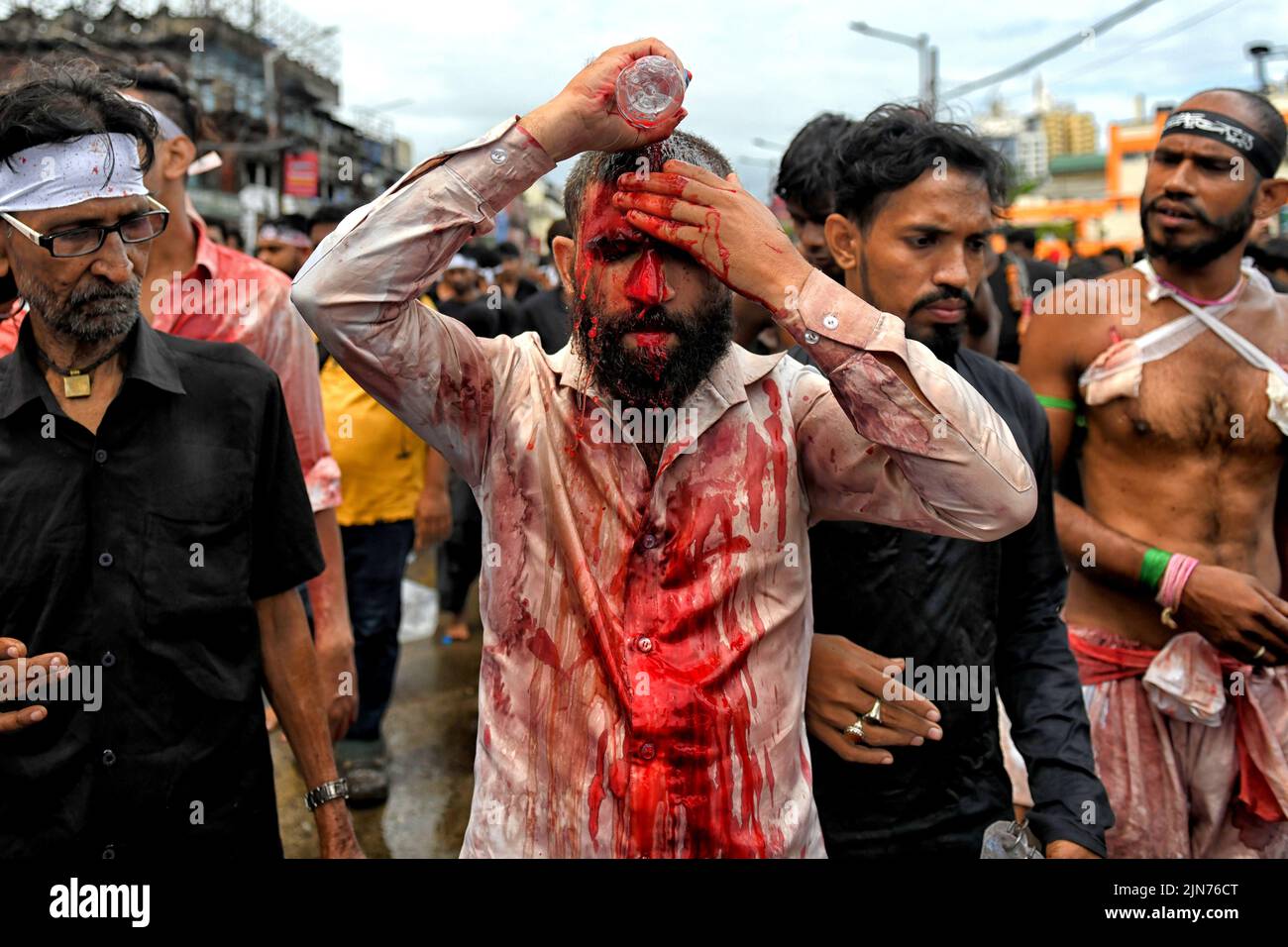 (EDITORS NOTE: Image contains graphic content.) A Shia Muslim devotee covers himself with blood after dangerously wounding himself with Swords while showing his grief during the Muharram procession of Kolkata. Muharram is the first month of the Islamic calendar & Ashura is the tenth day of the month of Muharram on which the commemoration of the martyrdom of Imam Hussain, the grandson of Prophet Muhammad (PBUH), during the battle of Karbala, is done. It is part of Mourning for Shia Muslims and a day of fasting for Sunni Muslims that is observed all over the World. Stock Photo
