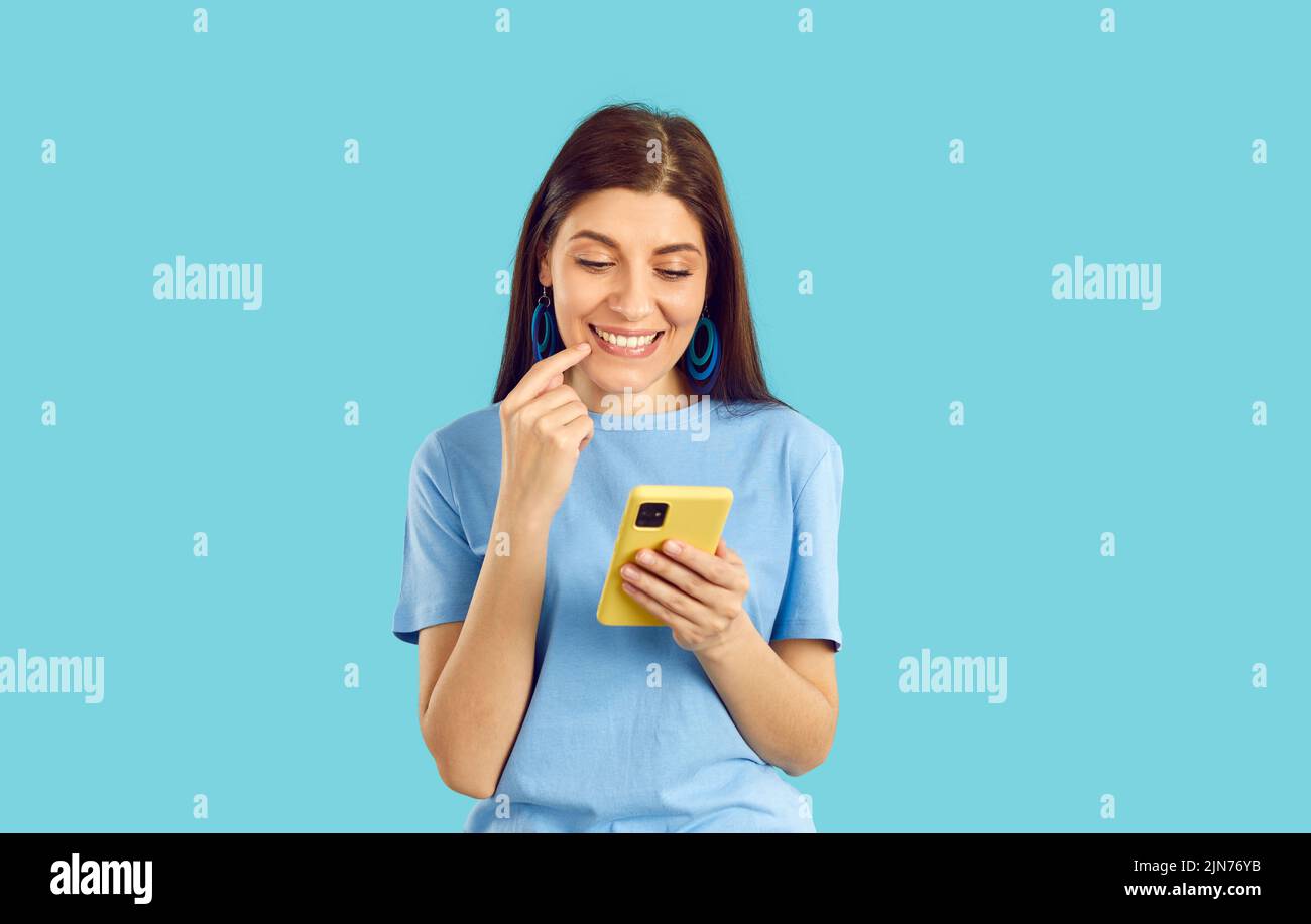 Happy young woman browse internet on cellphone Stock Photo