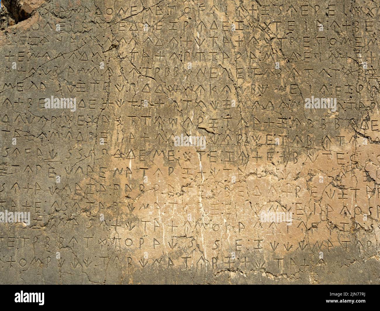 Ancient greek writing on stone wall of ancient city of Xanthos, Turkey