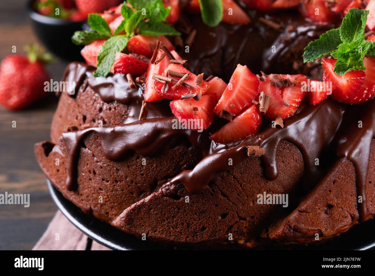 Dark Chocolate Bundt Cake with Ganache Icing and strawberry on dark ...