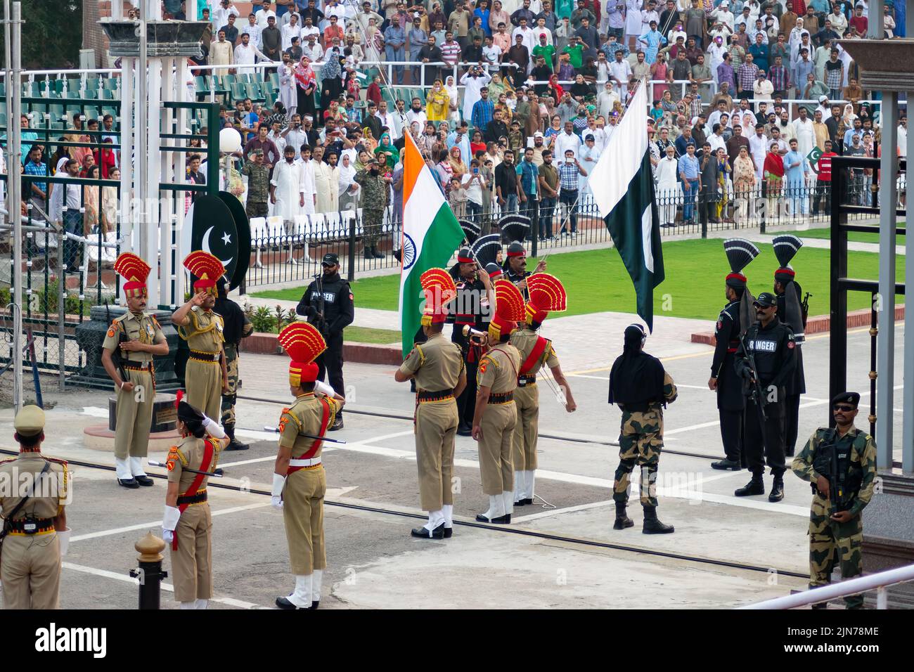 A shot of Indian and Pakistani soldiers during the Wagah-Attari border ceremony with national flags Stock Photo