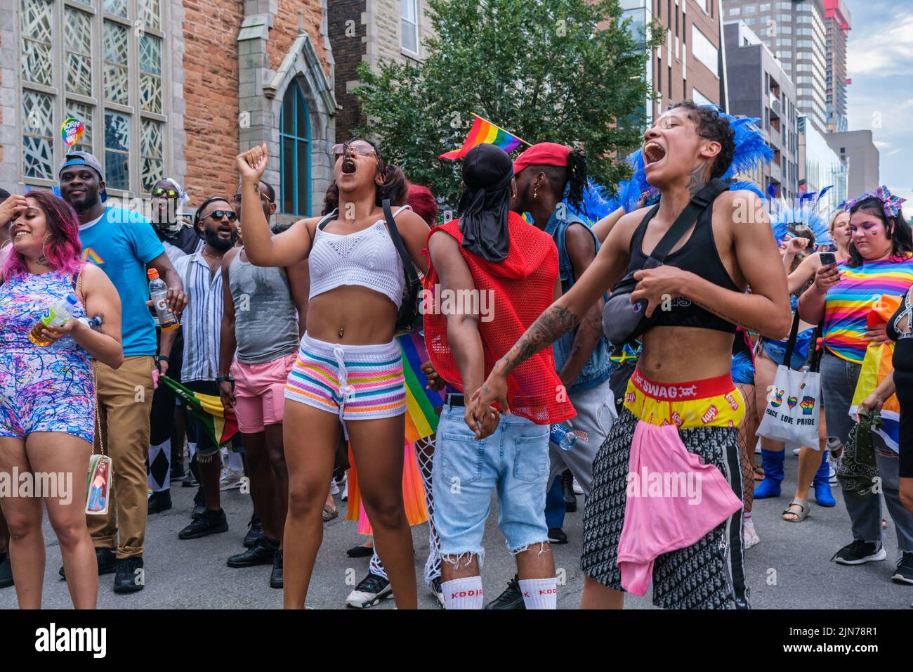Montreal, CA - 7 August 2022: Young people dancing during the spontaneous gay pride march after official pride parade was cancelled Stock Photo