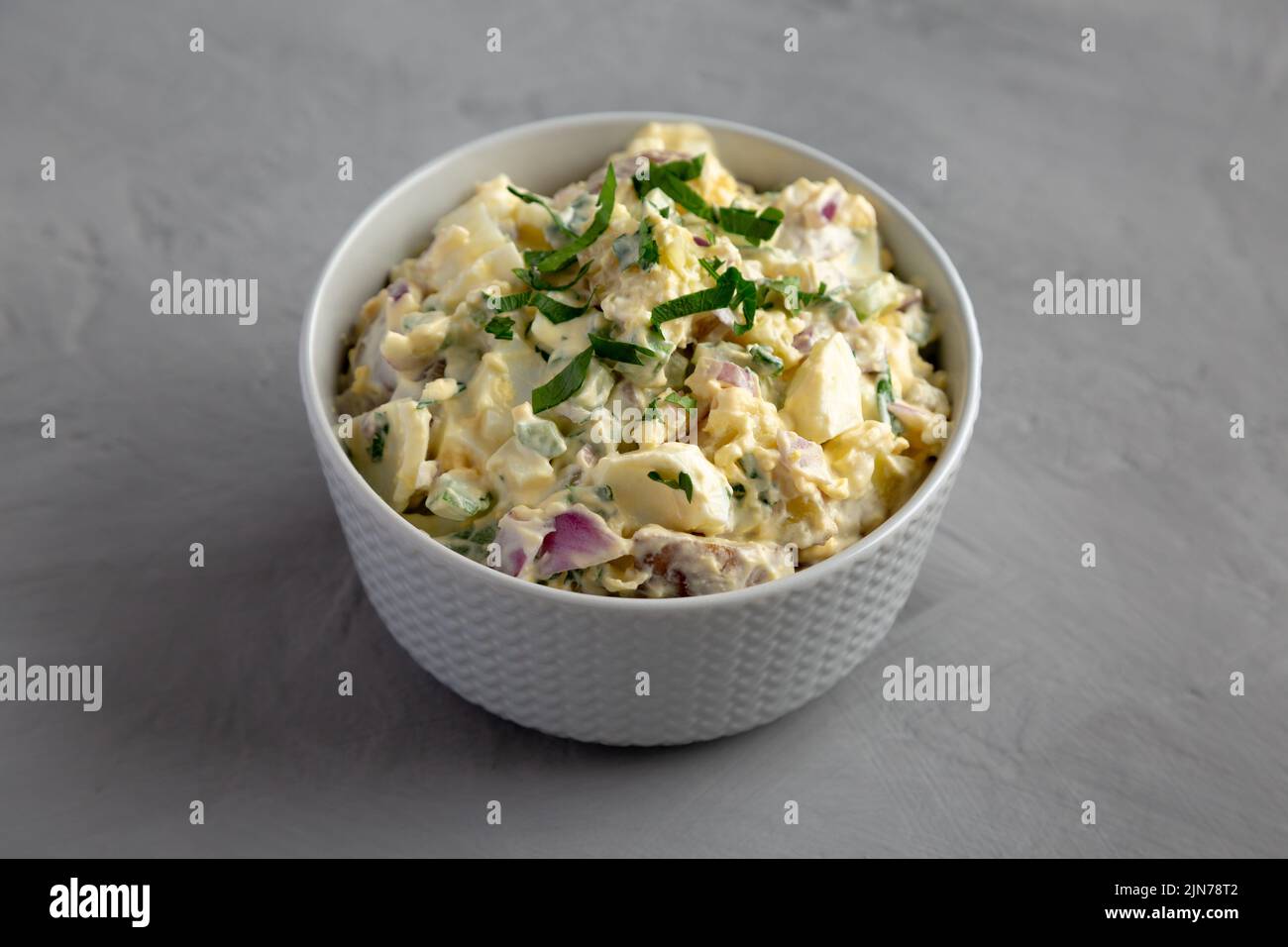 Homemade Healthy Potato Salad with Eggs in a Bowl on a gray background