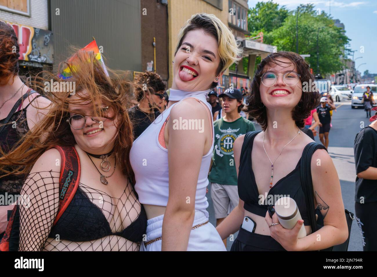 Montreal, CA - 7 August 2022: Three people take part in spontaneous gay pride march after official pride parade was cancelled Stock Photo