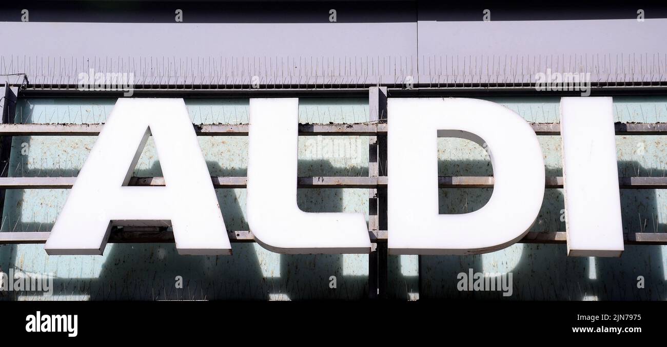 An exterior sign or signage or logo on the Aldi supermarket or shop or store, selling groceries, in central Manchester, United Kingdom, British Isles. Stock Photo