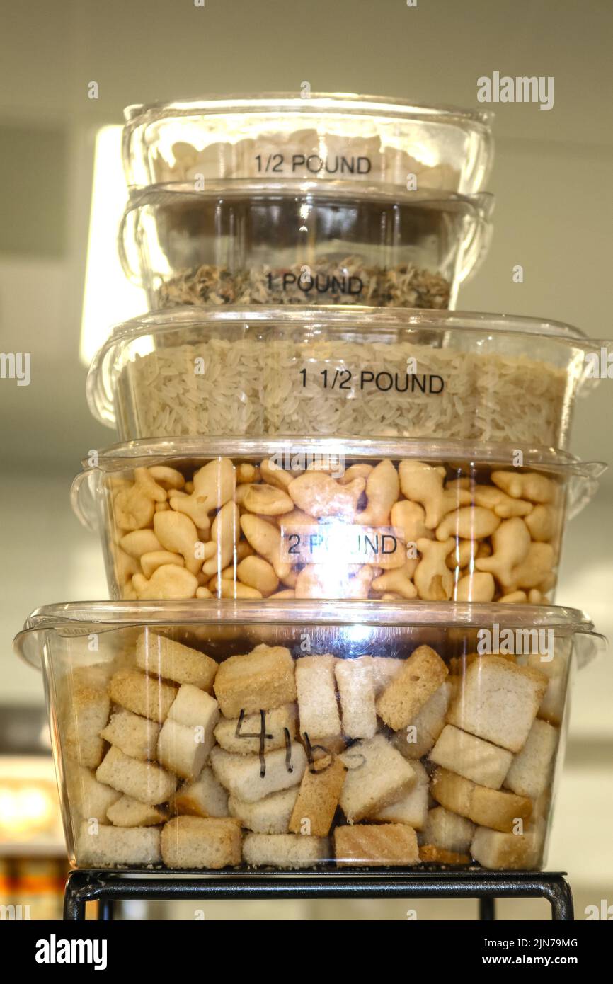 Stacked plastic to go containers holding assorted dry ingredients with different measurements written on them to demonstrate how much they will hold Stock Photo