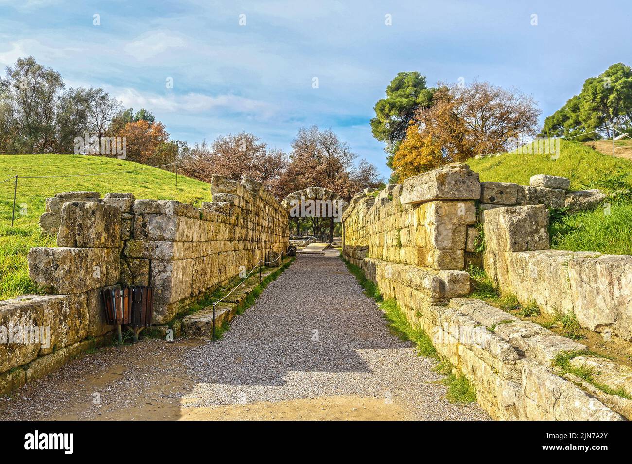 Stadium entrance and exit - Stone walls and arch leaving the field where first olympics took place in Olympia Greece. Stock Photo