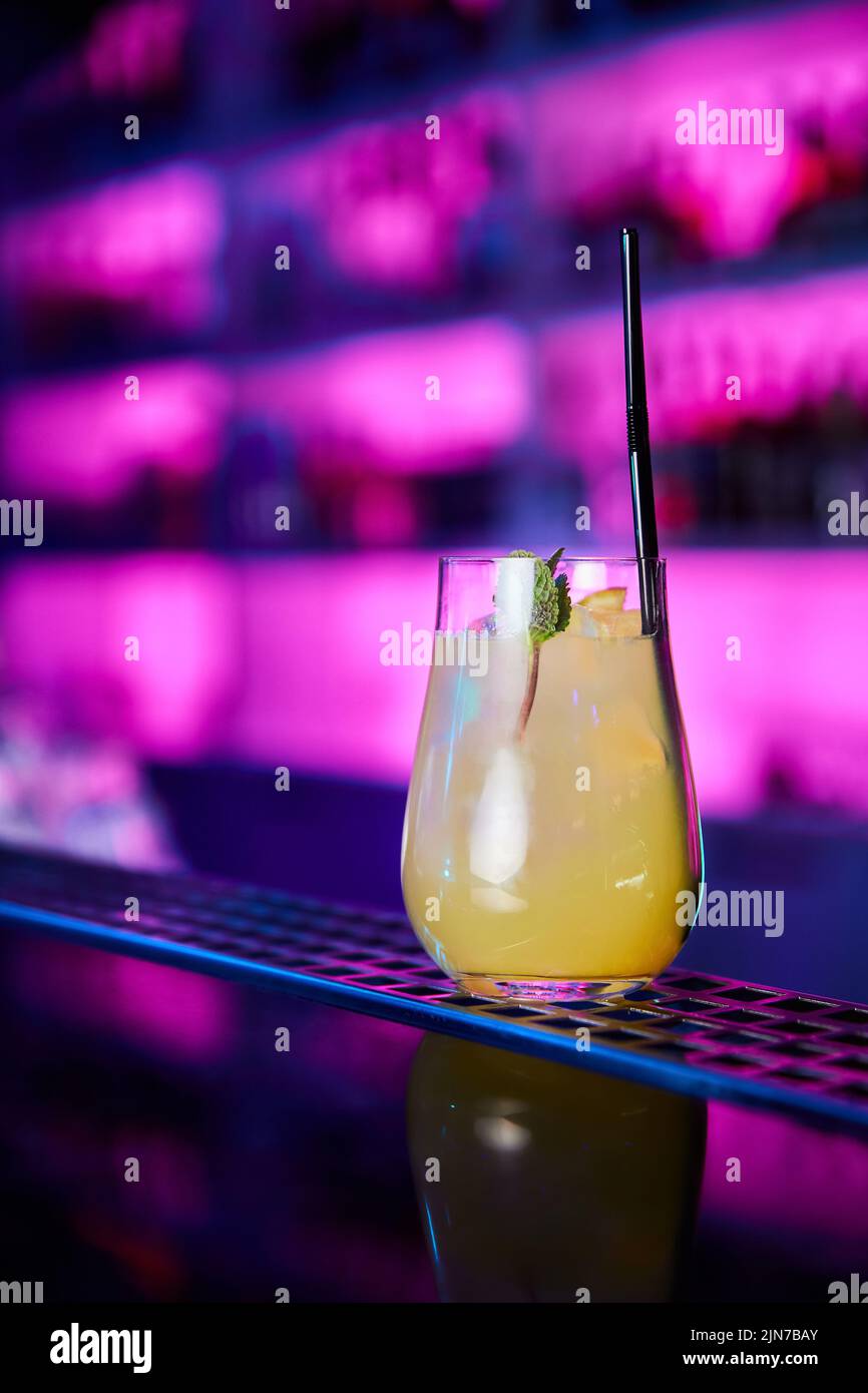 Orange alcoholic cocktail with mint and orange on the bar counter of a