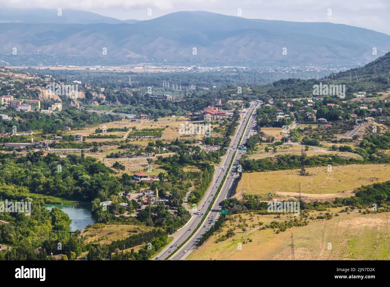 The countryside of the Republic of Georgia near Tbilisi where the highway branches north at Mtskheta near Jvari Monastery showing houses and farmland Stock Photo