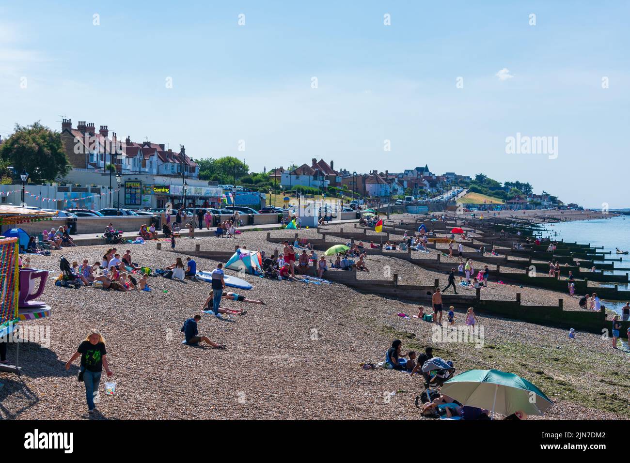 Herne Bay, Kent, UK - August 7 2022: Clear blue sky and warm temperatures with flocks of people swarming to the coast during an August weekend. Stock Photo