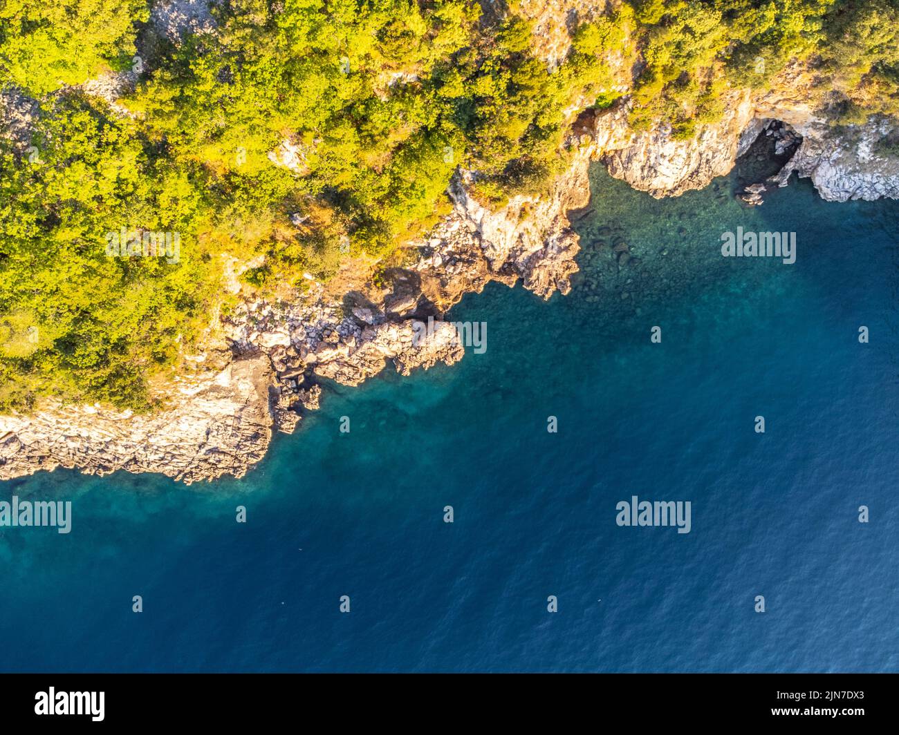 Rocky cliffs and blue sea on sunny summer day Stock Photo