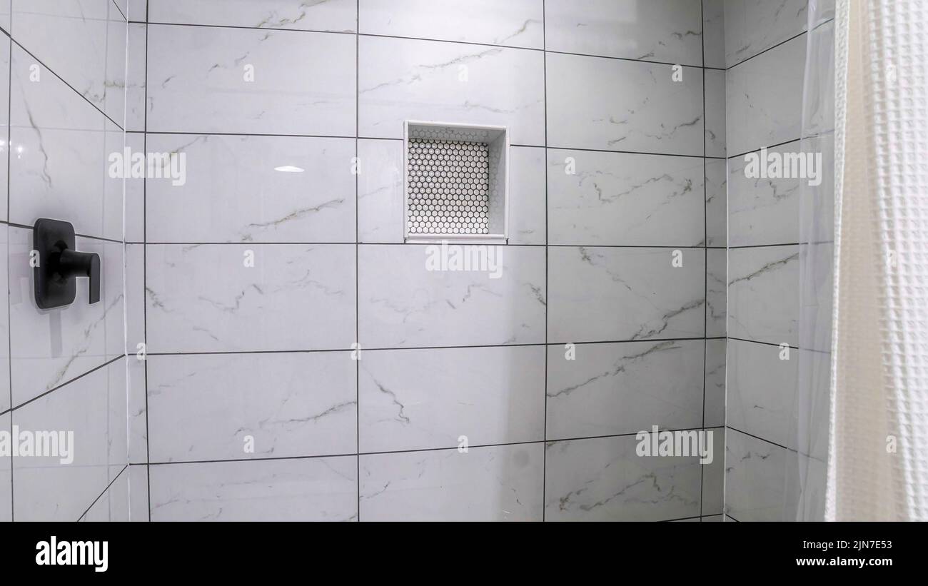 Panorama Shower stall with mosaic tiles flooring and marble tiles surround with black grout