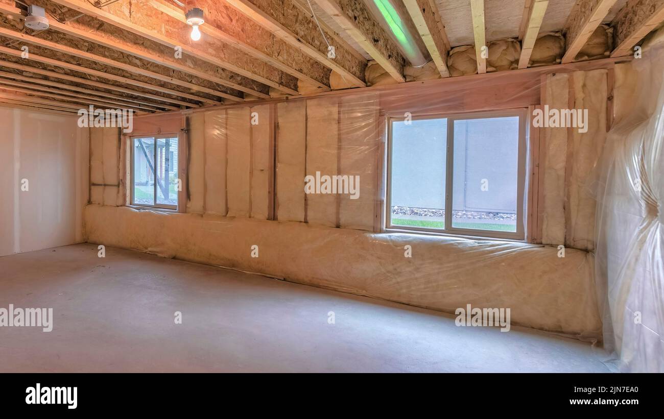 Panorama Unfinished basement with plastic vapor barrier and windows