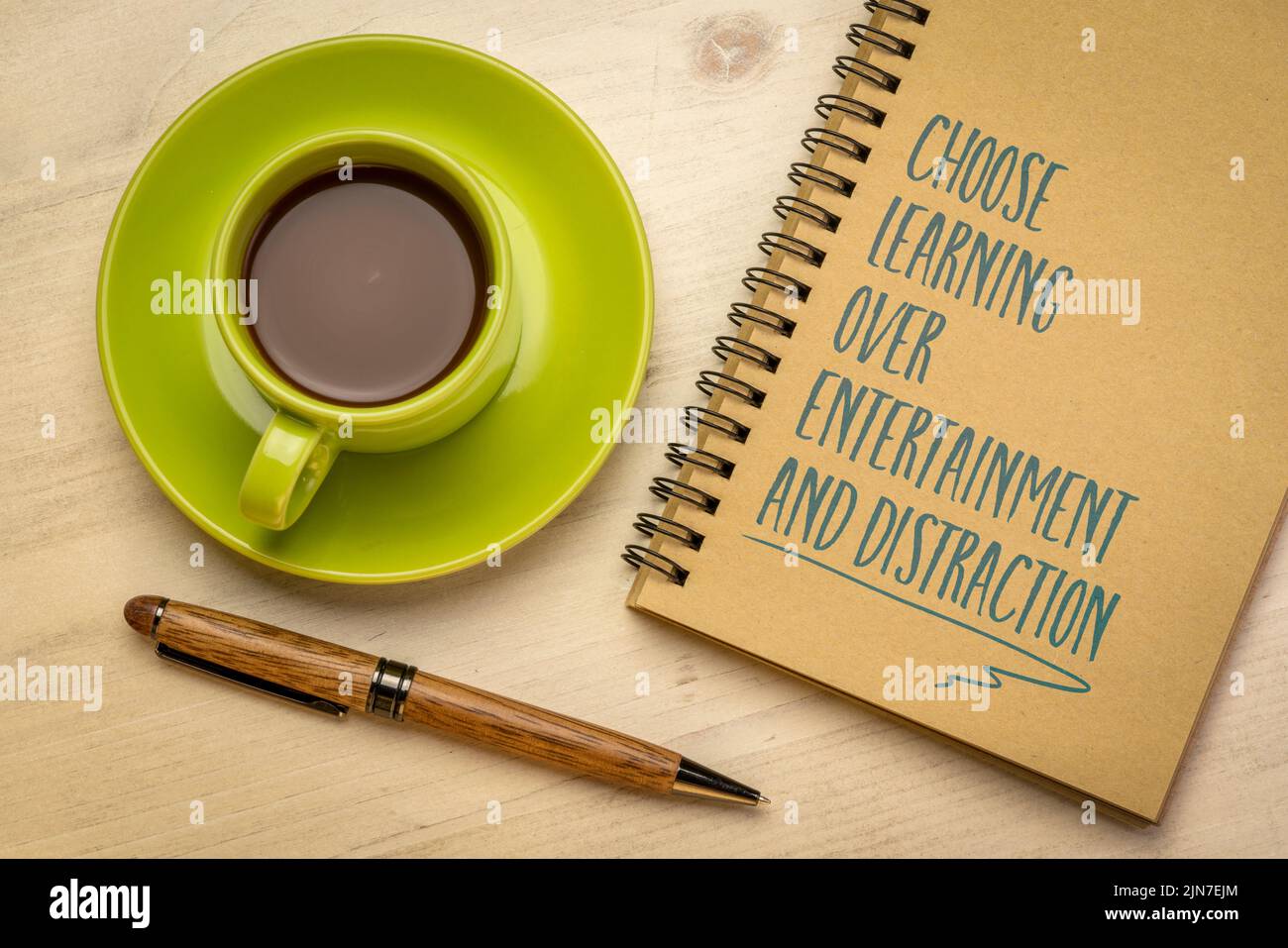 Choose learning over entertainment and distraction - inspirational note in a notebook, flat lay with coffee, learning and personal development concept Stock Photo