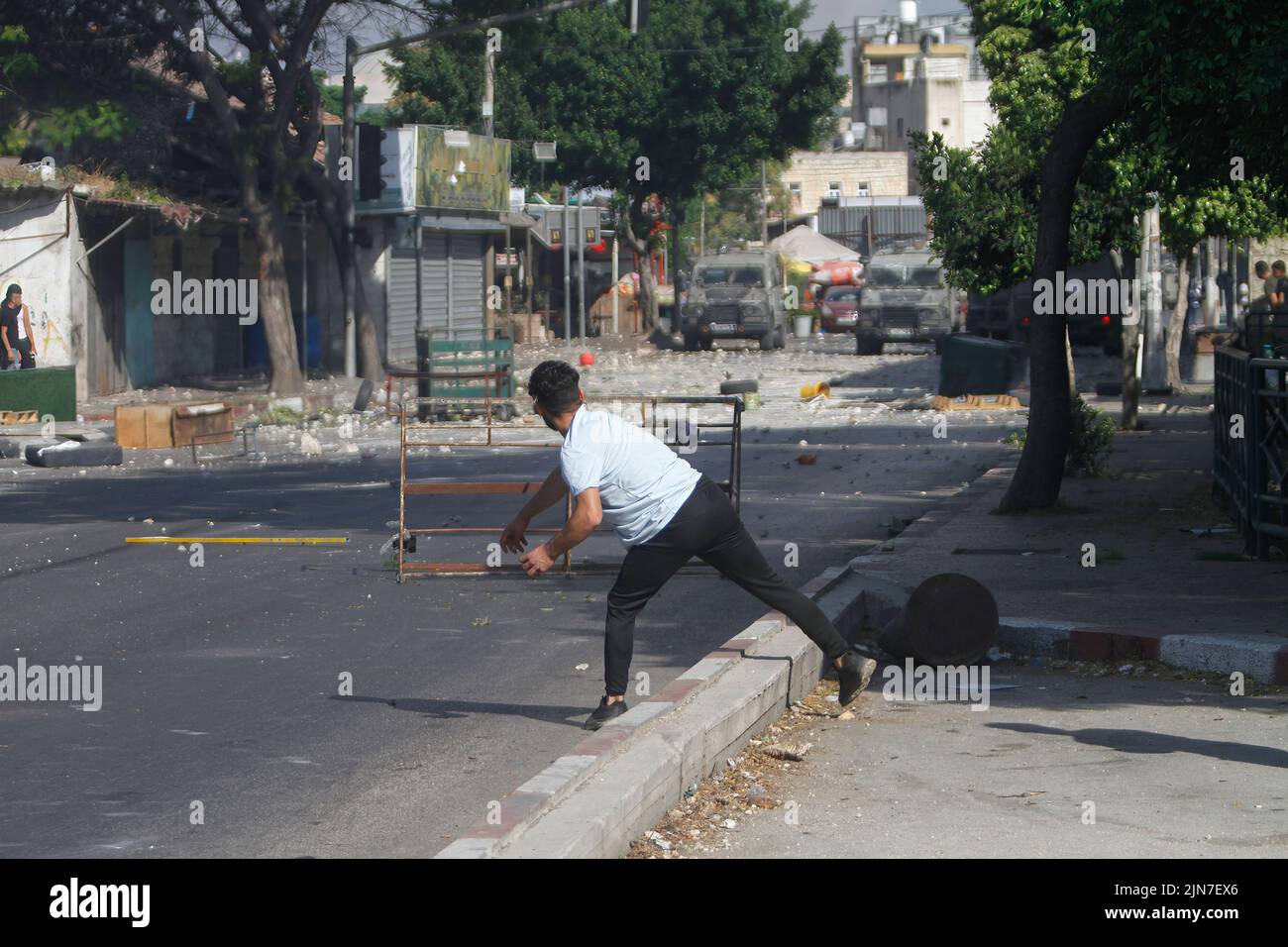 Nablus, Palestine. 02nd Aug, 2022. A Palestinian protester throws stones at military vehicles during the clashes with Israeli army forces after a raid in the Old City of Nablus in the occupied West Bank, the Palestinian Ministry of Health said that 3 Palestinians killed during the raid. Credit: SOPA Images Limited/Alamy Live News Stock Photo