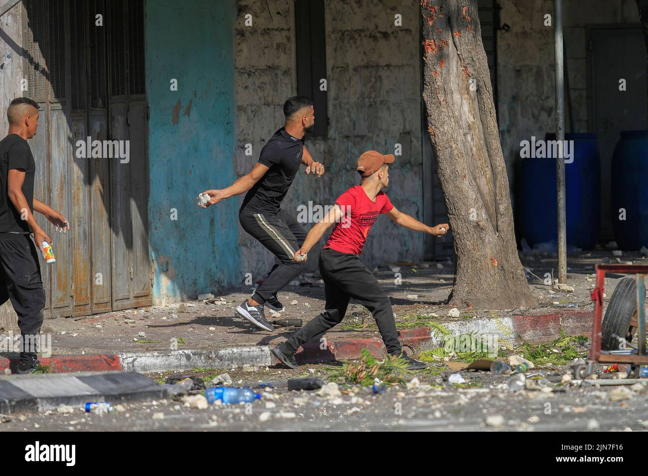 Nablus, Palestine. 02nd Aug, 2022. Palestinian protesters throw stones at military vehicles during the clashes with Israeli army forces after a raid in the Old City of Nablus in the occupied West Bank, the Palestinian Ministry of Health said that 3 Palestinians killed during the raid. Credit: SOPA Images Limited/Alamy Live News Stock Photo