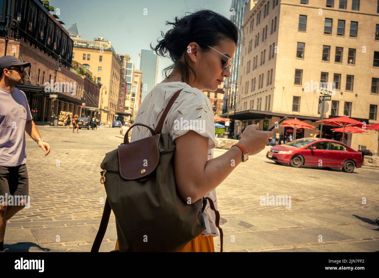 Distracted woman in the hot weather in the Meatpacking District in New York on Wednesday, August 3, 2022.  (© Richard B. Levine) Stock Photo