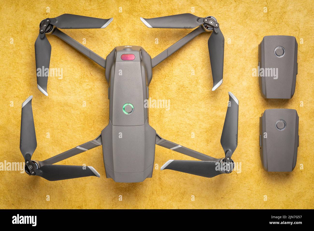 Fort Collins, CO, USA - March 10, 2019  Overhead view of DJI Mavic 2 pro drone with two spare batteries against textured handmade paper. Stock Photo