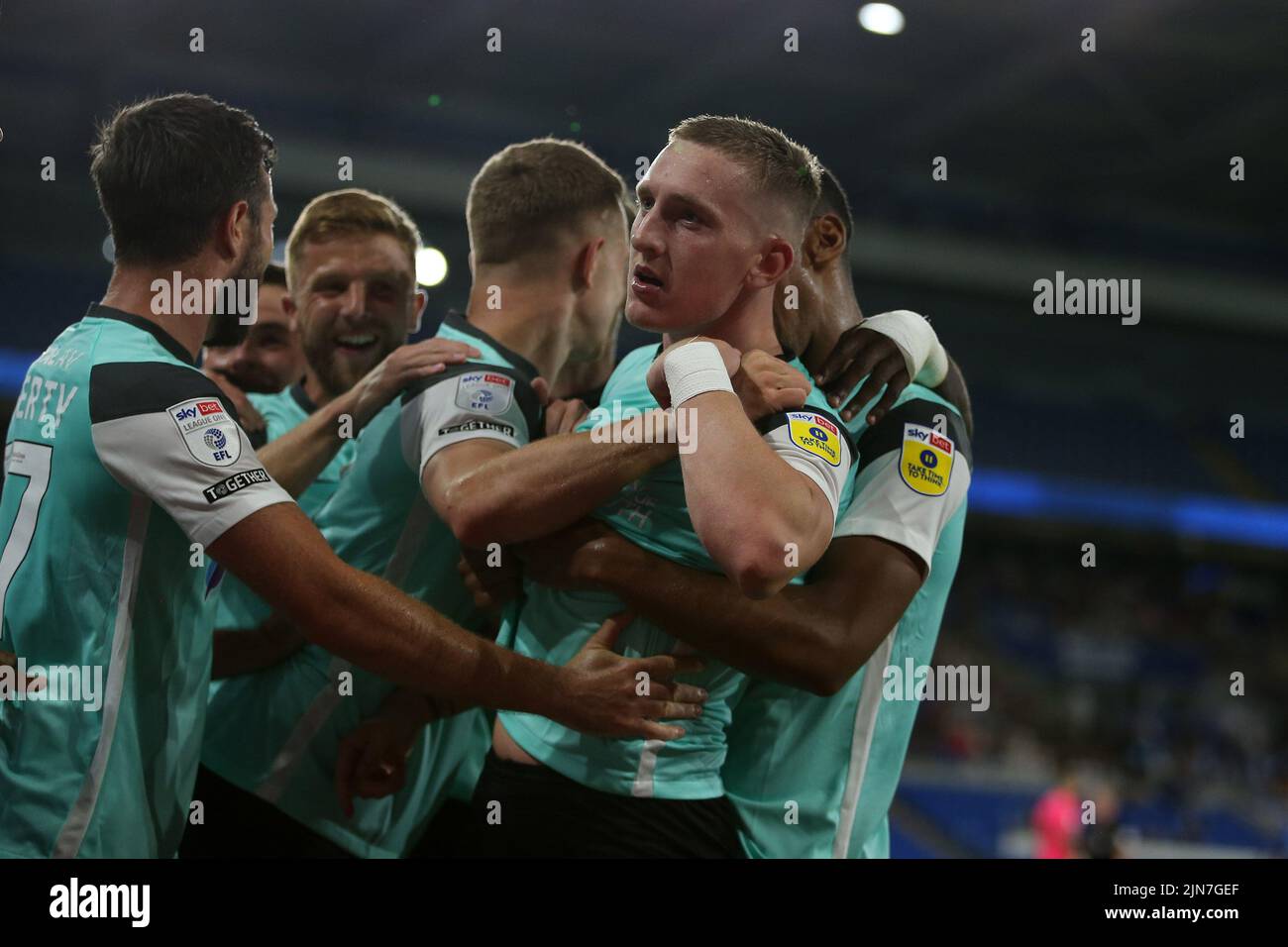 Cardiff, UK. 09th Aug, 2022. Ronan Curtis of Portsmouth (c) celebrates with teammates after he scores their 2nd goal from a penalty. EFL Carabao cup round 1 match, Cardiff city v Portsmouth at the Cardiff City Stadium in Cardiff, Wales on Tuesday 9th August 2022. this image may only be used for Editorial purposes. Editorial use only, license required for commercial use. No use in betting, games or a single club/league/player publications. pic by Andrew Orchard/Andrew Orchard sports photography/Alamy Live news Credit: Andrew Orchard sports photography/Alamy Live News Stock Photo